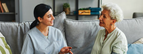 aide and elderly woman talking