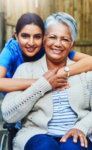 aide and elderly woman smiling