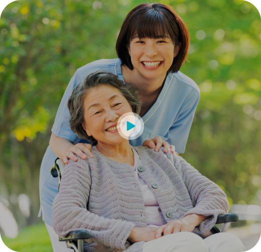 aide and elderly woman smiling