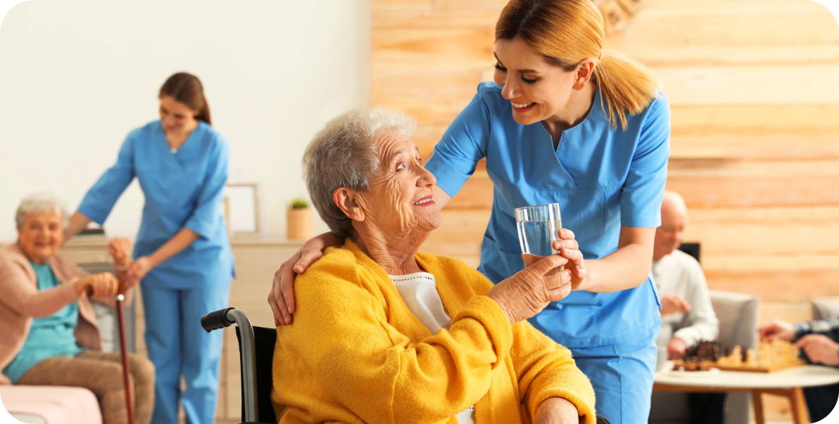 aide and elderly woman smiling at each other