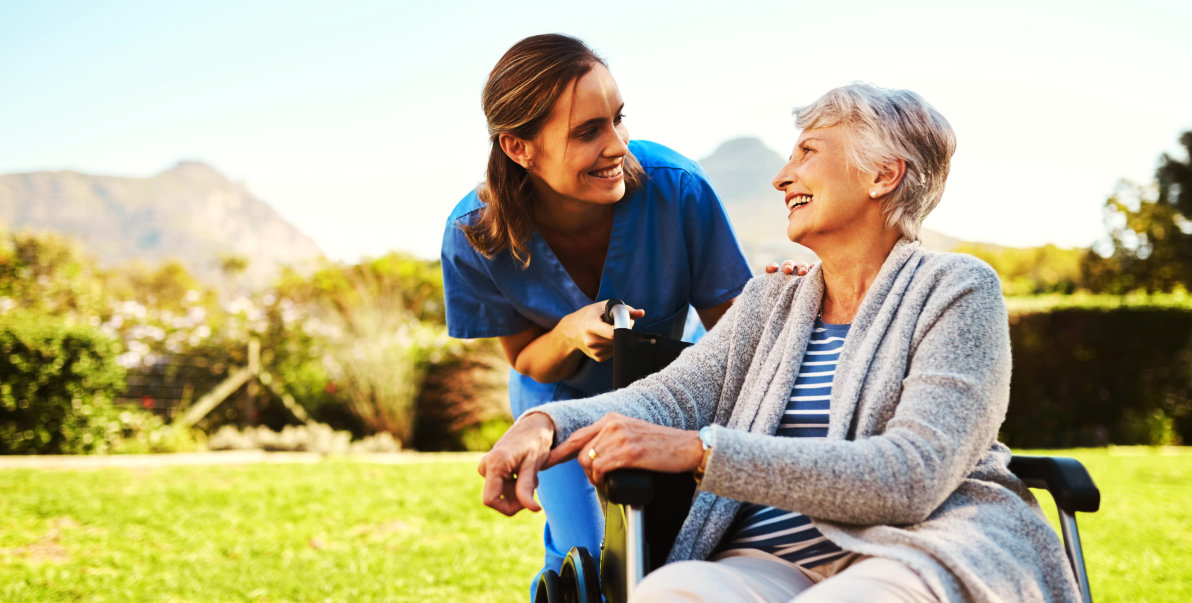 aide and elderly woman smiling