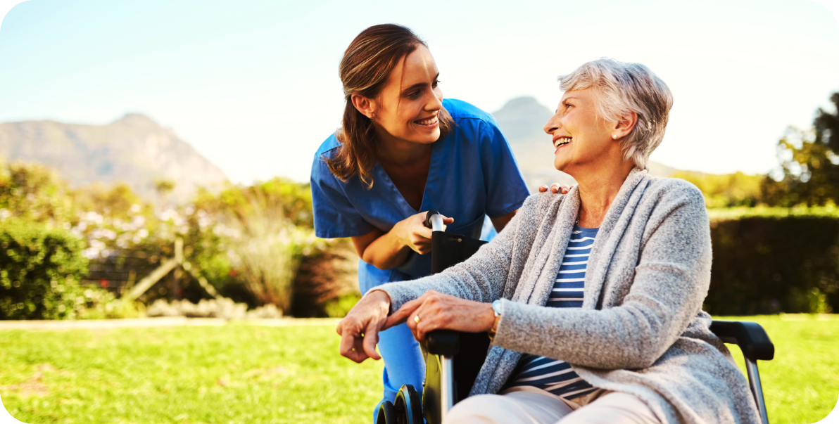 aide and elderly woman smiling