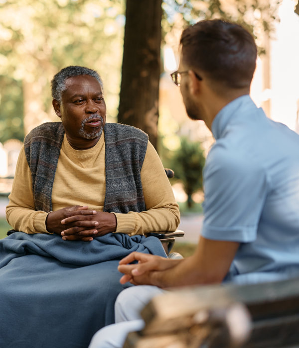 aide and elderly man talking