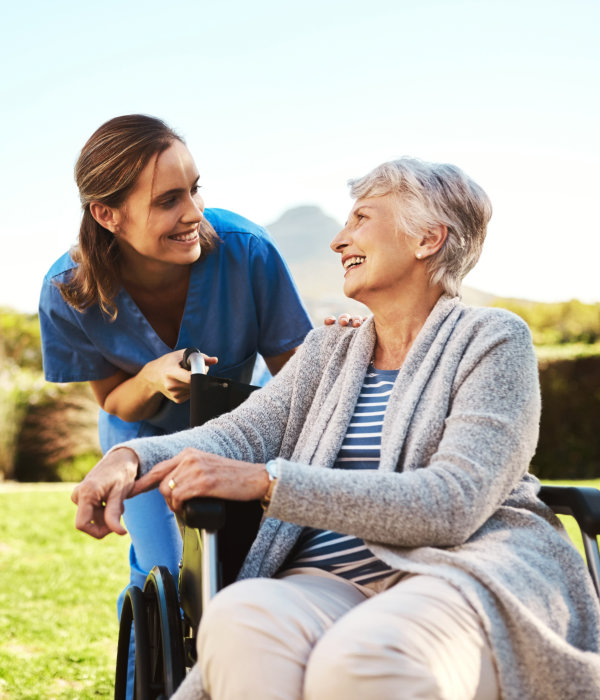 aide and elderly woman smiling