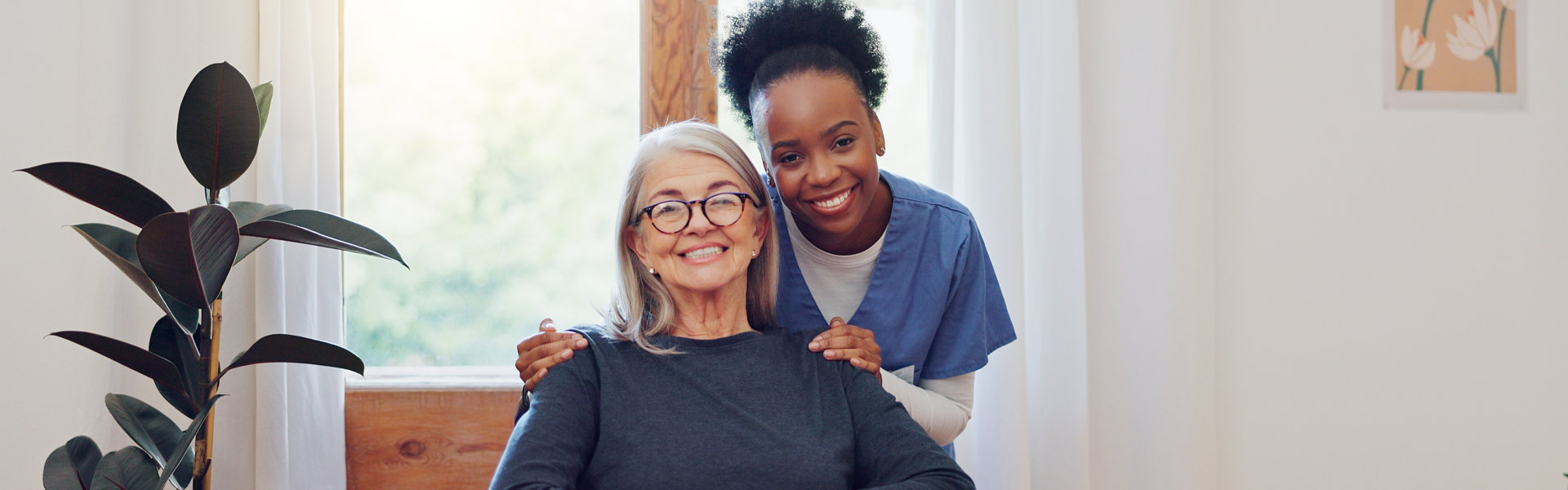 aide and elderly woman smiling