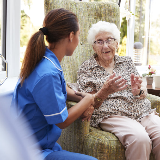 aide and elderly woman talking