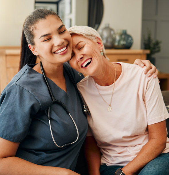 aide and elderly woman smiling