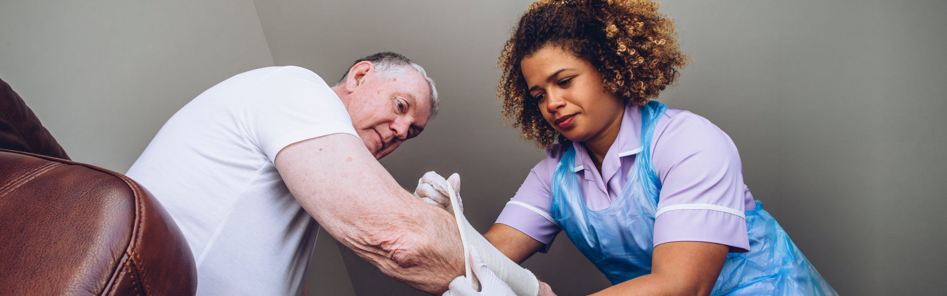 putting a bandage on elderly