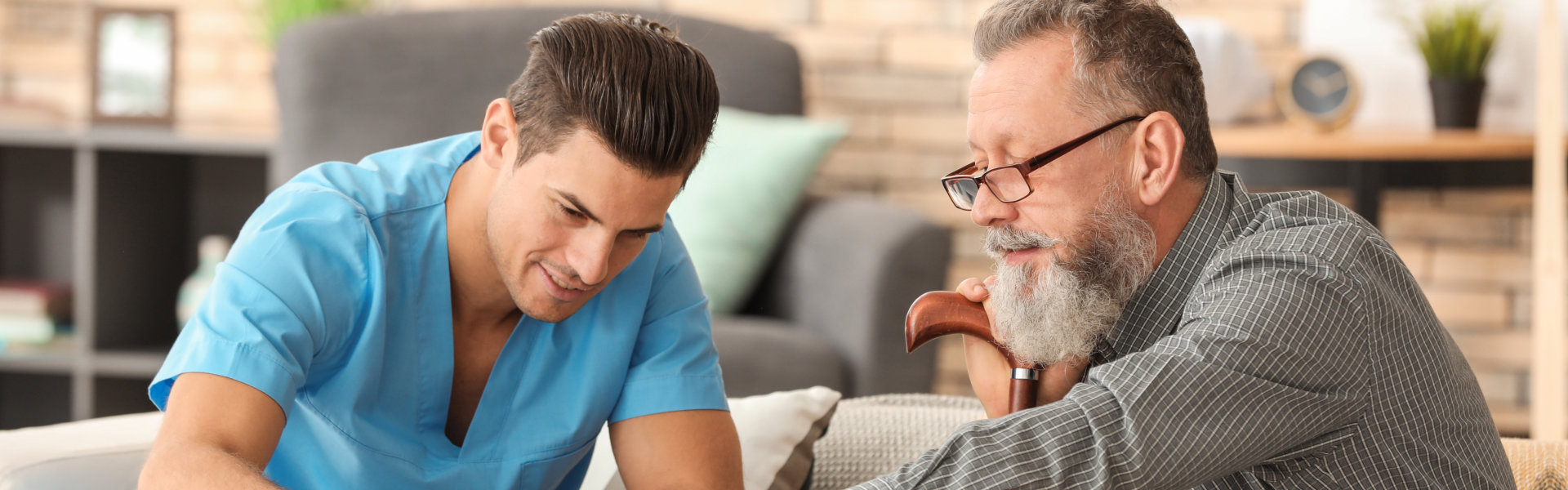 aide and elderly man playing board game