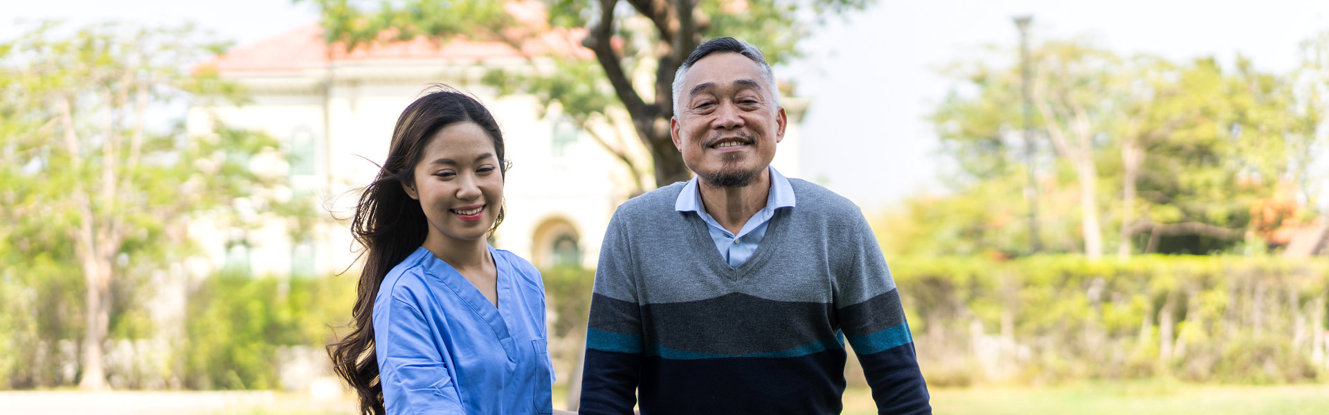 aide and elderly man smiling