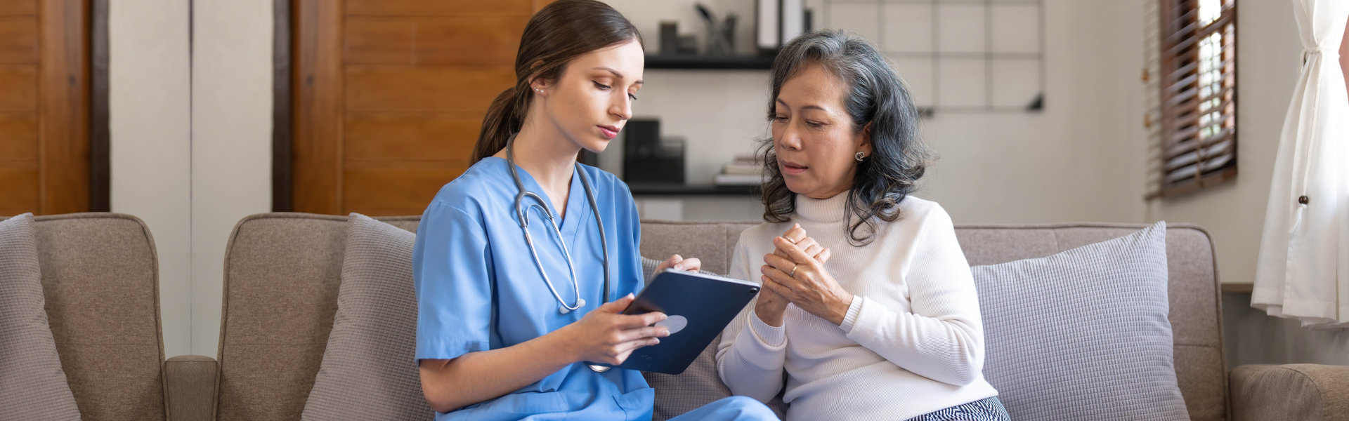 aide and elderly woman talking